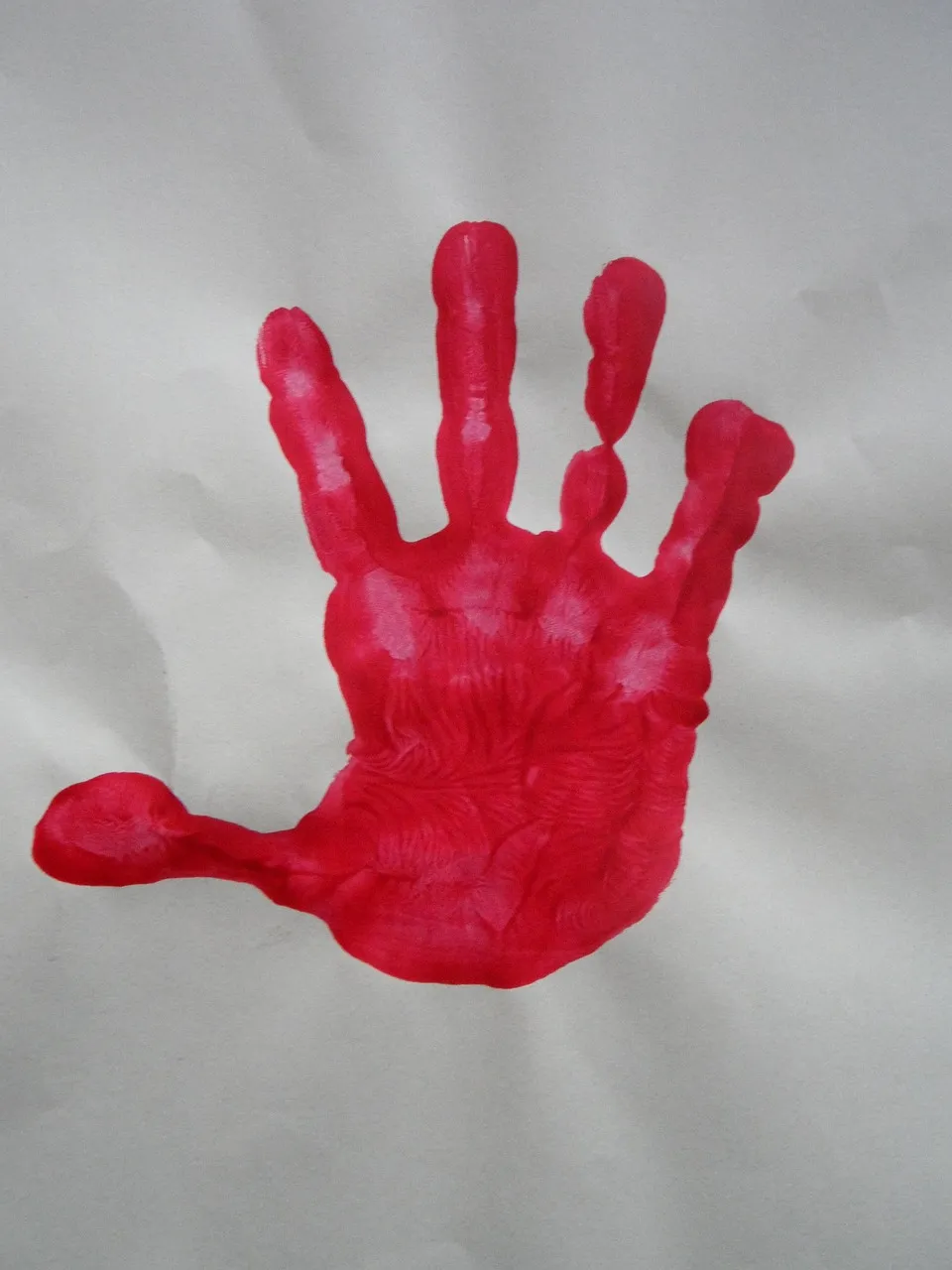 child with paint all over his hands