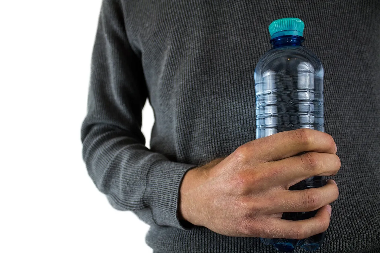 Plastic bottle jet pack with back straps and paper flames attached