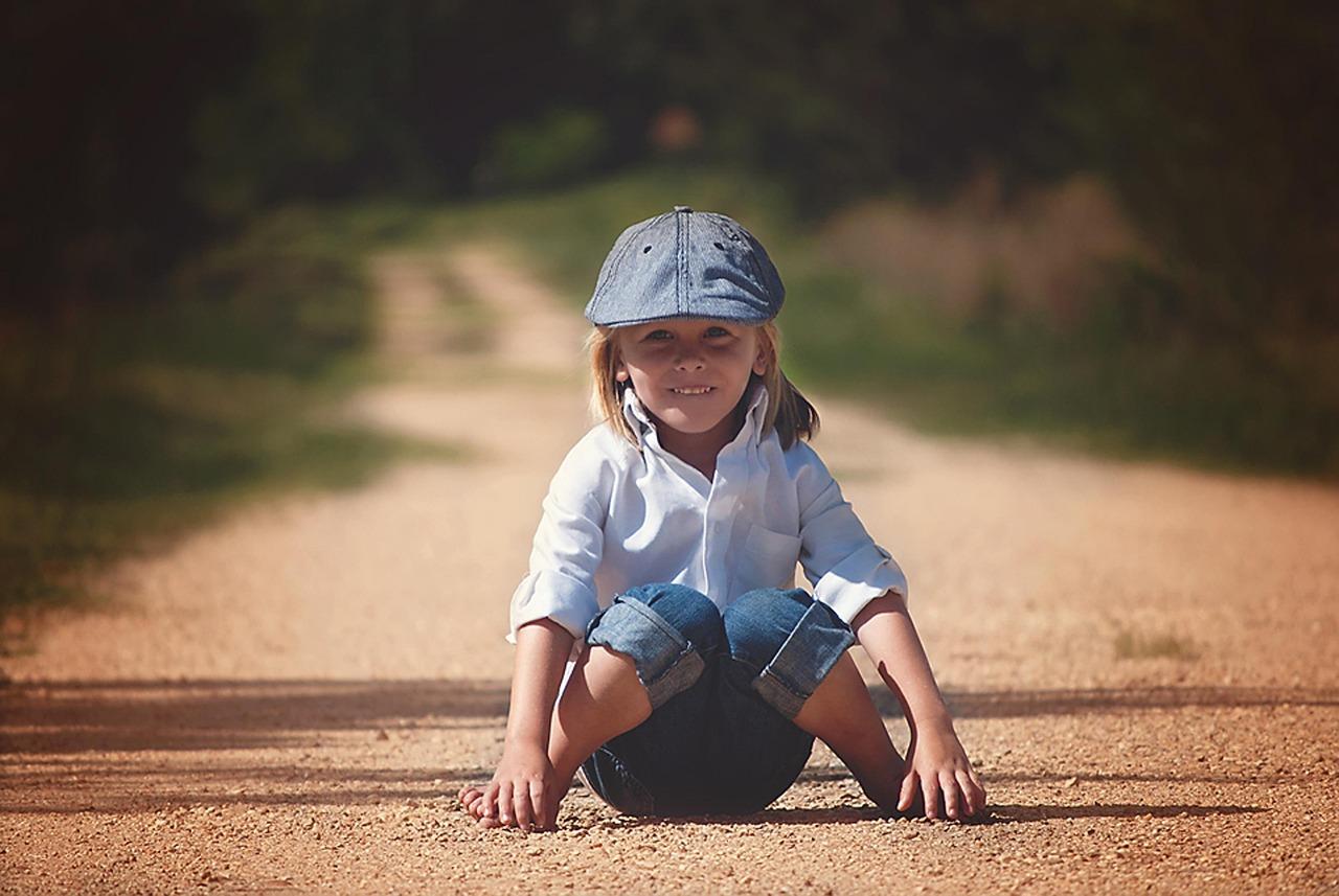 small boy pretending to be a ninja in the woods
