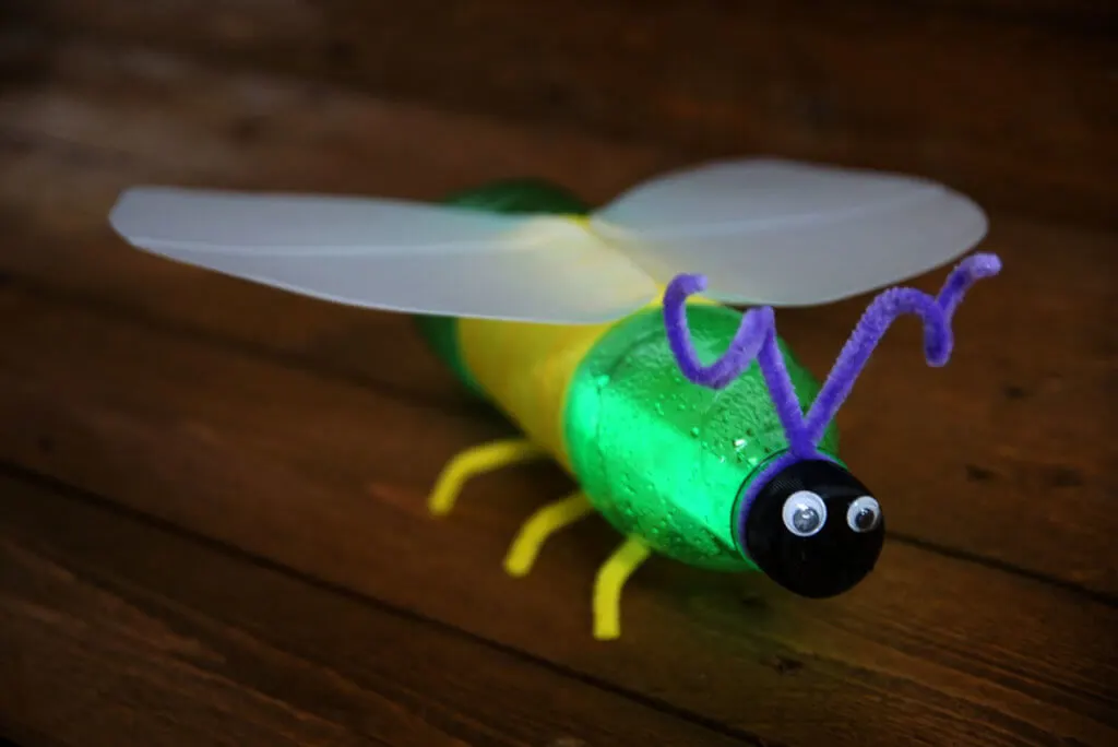 A glow bug made from recycled plastic soda bottles, seen from a side angle